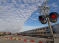 Commuter train at crossing Royalty Free Stock Photo