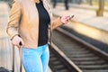 Commuter using smartphone in train station. Royalty Free Stock Photo