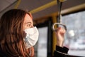 Commuter wears a protective mask in public transport.