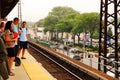 Commuters await their train