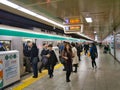 Commuters leave a crowded train on the busy subway / underground at a station in Kyoto, Japan Royalty Free Stock Photo