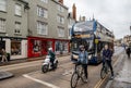 Commuters men and women on moped city Oxford UK