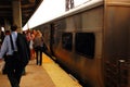 Commuters prepare to board the train during the morning rush