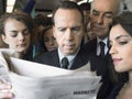 Commuters Reading Newspaper In Train Royalty Free Stock Photo