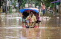 Commuters on a rickshaw to cross a waterlogged road after heavy rainfall, on October 6, 2023 in Guwahati, Assam, India. Severe wat