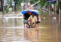 Commuters on a rickshaw to cross a waterlogged road after heavy rainfall, on October 6, 2023 in Guwahati, Assam, India. Severe wat