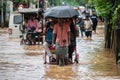 Commuters on a rickshaw to cross a waterlogged road after heavy rainfall, on October 6, 2023 in Guwahati, Assam, India. Severe wat