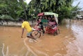 Commuters on a rickshaw to cross a waterlogged road after heavy rainfall, on October 6, 2023 in Guwahati, Assam, India. Severe wat