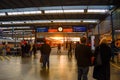 Commuters talk while waiting for their train to arrive