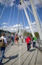 Commuters and tourists on Golden Jubilee Bridge, London.