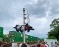 Commuters wait for a freight train to pass through Villa Park, IL at the railroad crossing above ground