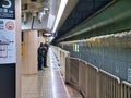 Commuters wait at a subway / underground at a station in Fukuoka, Japan