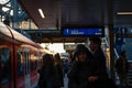 Commuters wait for a train to stop before boarding