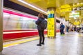 Commuters wait for the train to stop to get on at one of the subway stations in Tokyo, Japan