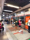 Commuters waiting to board at the City Hall station on the Singapore Mass Rapid Transit network Royalty Free Stock Photo