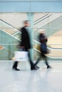 Commuters Walking Quickly down Hall in Office Building Royalty Free Stock Photo