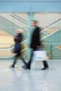 Commuters Walking Quickly down Hall in Office Building Royalty Free Stock Photo