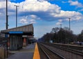 Commuters on station platform after Metra train passes through a Chicago suburb`s train station Royalty Free Stock Photo
