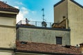 Como, ITALY - August 4, 2019: Mature lady on the open wide terrace on the roof of her house near Lake Como. Beautiful Italian Como