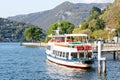 Como, Italy - October, 2019: Conventional ferry Innominato stopped at the dock in Como city. Public motor ship arrived Royalty Free Stock Photo