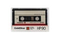 Compact audio cassette Goldstar isolated. Back view compact audio cassette Goldstar HP 90 in transparent case box. IEC type I