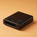A compact black electronic device, potentially a portable printer, is placed against an Royalty Free Stock Photo