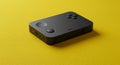 A compact, black handheld device with rounded edges and multiple buttons on its