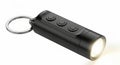 Compact black led mini keychain flashlight with multiple buttons and ring Royalty Free Stock Photo