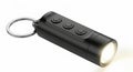 Compact black led mini keychain flashlight with multiple buttons and ring Royalty Free Stock Photo