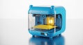 Compact blue 3d printer creating a yellow object with bright interior lights white background Royalty Free Stock Photo