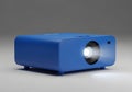 Compact blue projector emitting a bright beam of light on a neutral background Royalty Free Stock Photo