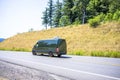 Compact cargo dark gray mini van running for delivery on the winding summery road