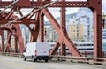 Compact cargo white mini van running on the Broadway Bridge in Portland Royalty Free Stock Photo