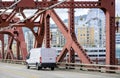 Compact cargo white mini van running on the Broadway Bridge in Portland