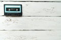 Compact Cassette Magnetic audio tape manufacturer lying on white wooden table. Retro and vintage audio music reproduction concept Royalty Free Stock Photo