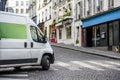 Compact economical mini van for small business and local delivery turning on crossroad on the city street