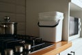 Compact compost bin on a kitchen counter. Domestic bokashi container for recycling organic waste