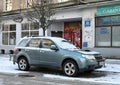 Old veteran grey blue compact crossover suv car Subaru Forester third generation parked in snow