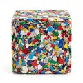 A compact cube of brightly colored compressed recycled plastic waste stands as a symbol of sustainability. Royalty Free Stock Photo