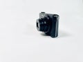 Compact digital camera with a sleek black casing set against a plain white background. Royalty Free Stock Photo