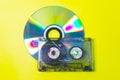 Compact disc and audio cassette on a yellow background Royalty Free Stock Photo