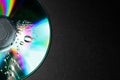 Compact disc with drops on black background, top view. Space for text Royalty Free Stock Photo