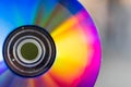 Compact Disc. Holding a CD in hands. The back side of the CD reflects colorful lights. Rainbow colors Royalty Free Stock Photo