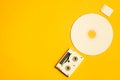 Compact disc and memory card on yellow background. digital video cassette. copy space Royalty Free Stock Photo