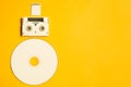 Compact disc and memory card on yellow background. digital video cassette. copy space Royalty Free Stock Photo