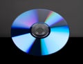 Compact disc reflecting colorful light spectrum on black surface, technology media storage concept Royalty Free Stock Photo