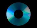 Compact disc with reflective surface showing blue and green light reflections on black background Royalty Free Stock Photo