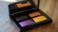 A compact eyeshadow palette featuring four vibrant shades for makeup application Royalty Free Stock Photo