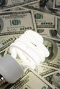 Compact Fluorescent Light bulb and dollar Royalty Free Stock Photo
