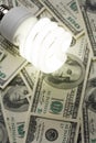 Compact Fluorescent Light bulb and dollar Royalty Free Stock Photo